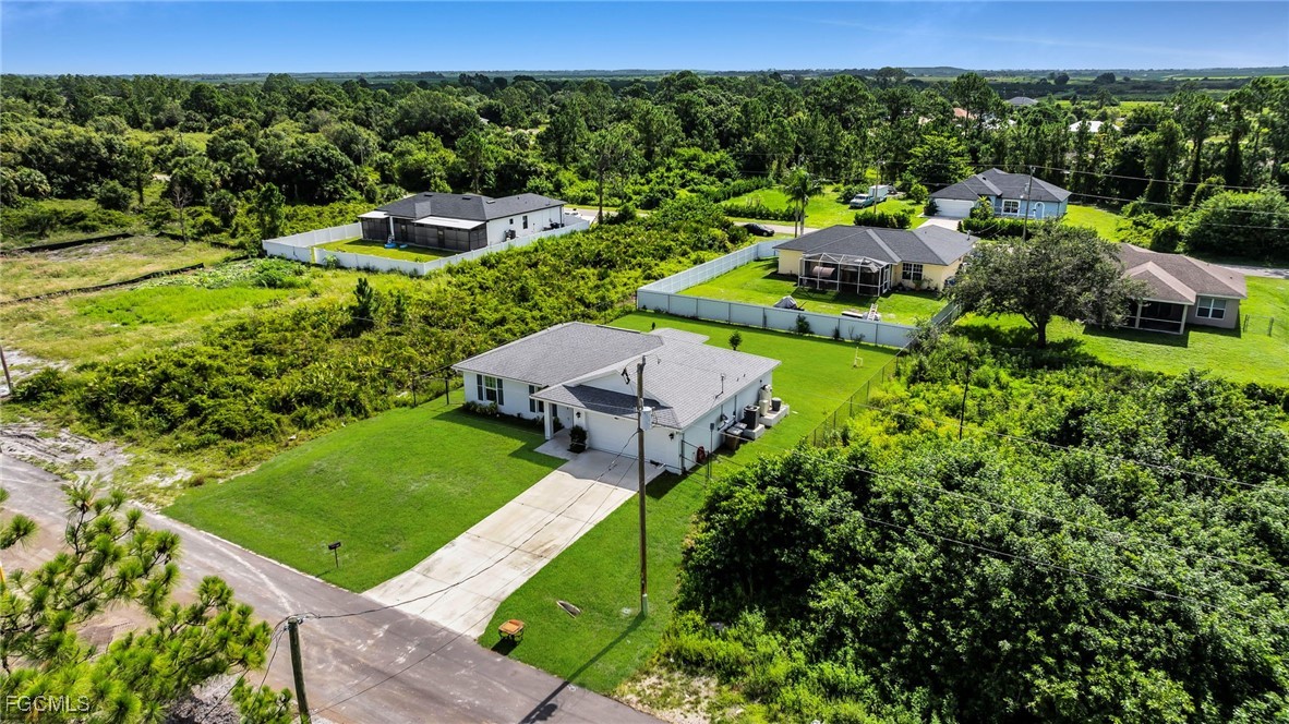 767 Roma Avenue South Lehigh Acres, FL 33974 - Photo 13 of 34 an aerial view of a house with yard
