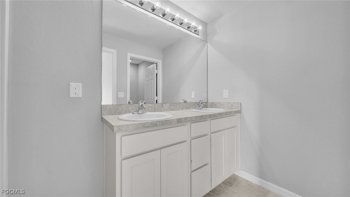 767 Roma Avenue South Lehigh Acres, FL 33974 - Photo 30 of 34 a bathroom with a sink and a mirror