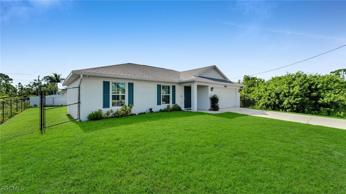 767 Roma Avenue South Lehigh Acres, FL 33974 - Photo 4 of 34 a view of a house with a backyard