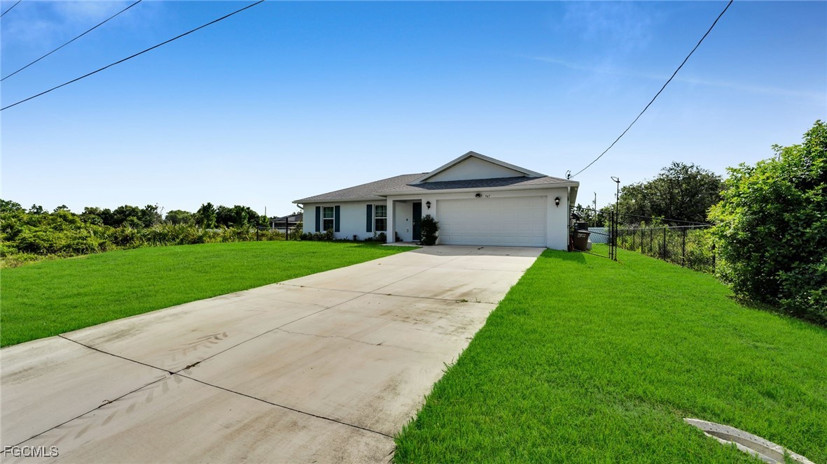 767 Roma Avenue South Lehigh Acres, FL 33974 - Photo 5 of 34 a front view of a house with yard