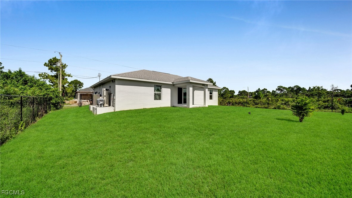 767 Roma Avenue South Lehigh Acres, FL 33974 - Photo 7 of 34 a view of a house with a big yard