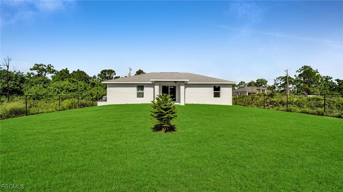 767 Roma Avenue South Lehigh Acres, FL 33974 - Photo 8 of 34 a front view of a house with a garden