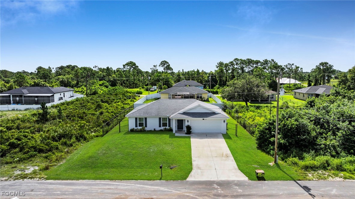 767 Roma Avenue South Lehigh Acres, FL 33974 - Photo 10 of 34 a front view of a house with a yard