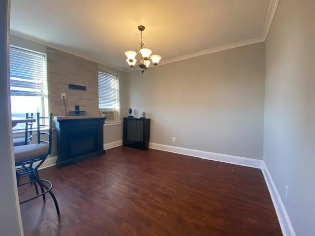 a view of a livingroom with a kitchen counter tops and a chandelier fan