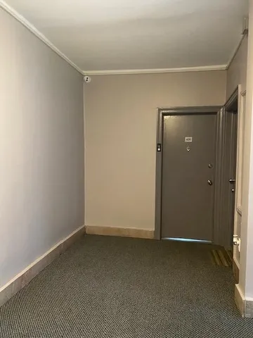 an empty room with closet and mirror
