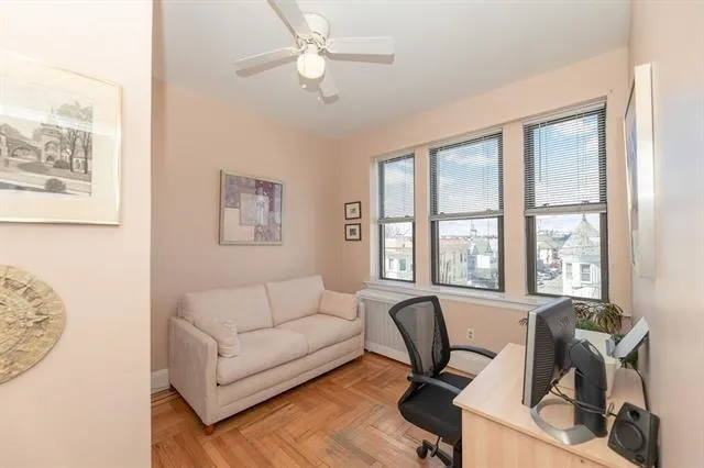 a view of a livingroom with workspace and a couch