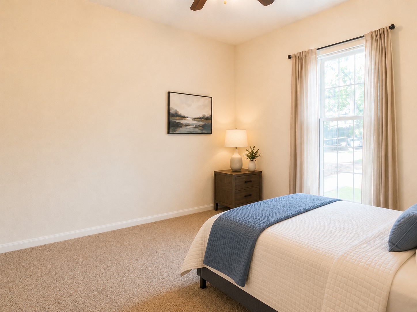 207 Kates Way Hutto, TX 78634 - Photo 11 of 24 Carpeted room featuring a large window with vertical grids, a ceiling fan, and light-toned walls.
Virtually staged.
