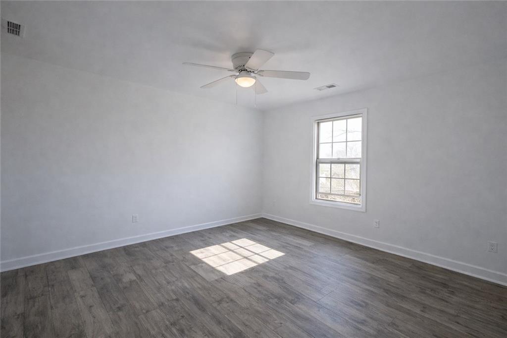 1488 East Forrest Avenue Atlanta, GA 30344 - Photo 3 of 7 wooden floor in an empty room with a window