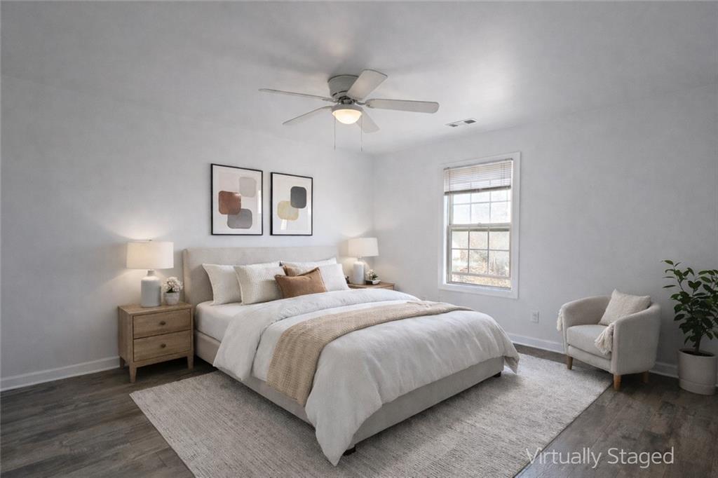 1488 East Forrest Avenue Atlanta, GA 30344 - Photo 4 of 7 a bedroom with a bed and a couch