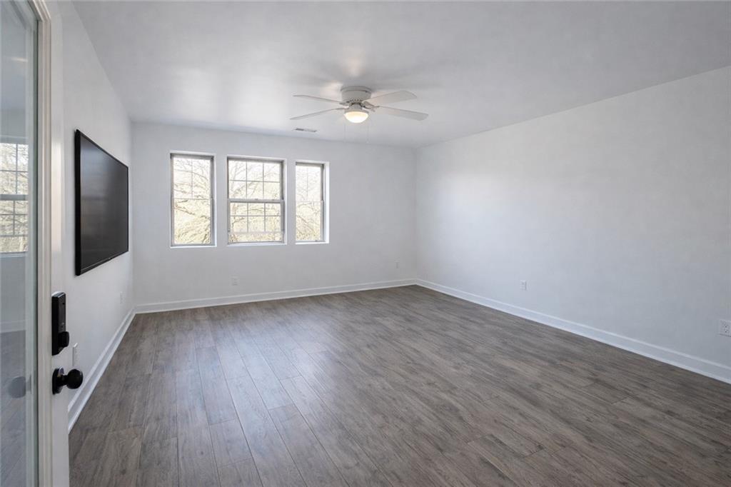 1488 East Forrest Avenue Atlanta, GA 30344 - Photo 5 of 7 an empty room with wooden floor and windows