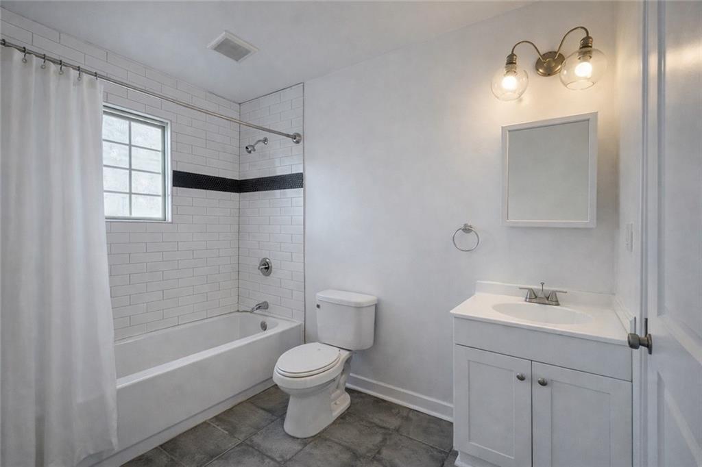 1488 East Forrest Avenue Atlanta, GA 30344 - Photo 7 of 7 a bathroom with a sink a toilet and shower