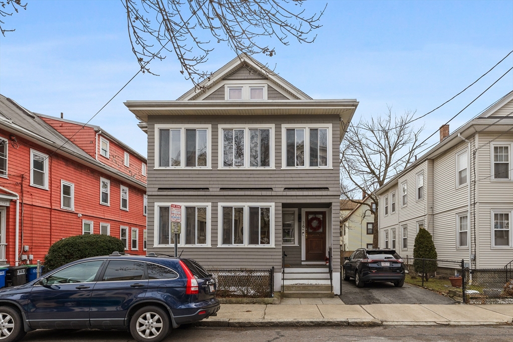 a front view of a residential apartment building with a yard
