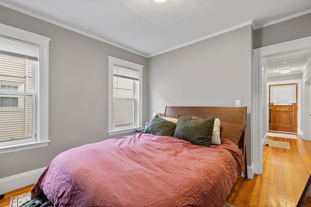 14-16 Malvern Avenue Somerville, MA 02144 - Photo 11 of 39 a bedroom with a bed and wooden floor