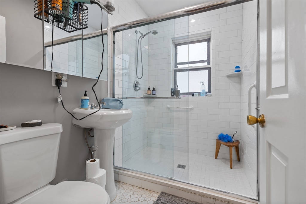 14-16 Malvern Avenue Somerville, MA 02144 - Photo 12 of 39 a bathroom with a sink a toilet and shower