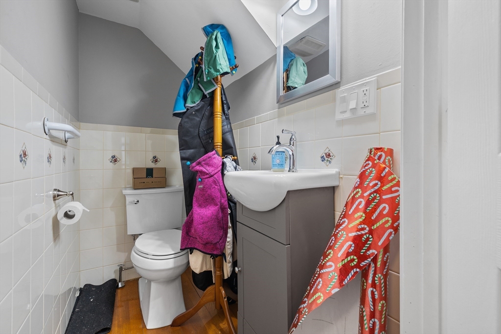 14-16 Malvern Avenue Somerville, MA 02144 - Photo 14 of 39 a white toilet sitting next to a bathroom sink and vanity