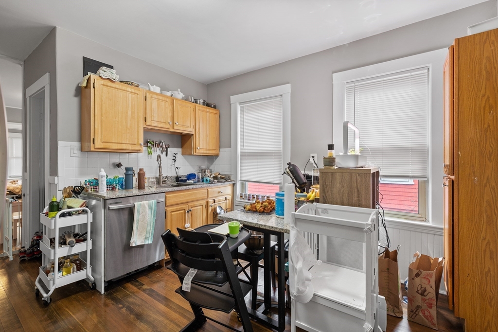14-16 Malvern Avenue Somerville, MA 02144 - Photo 17 of 39 a kitchen with a table chairs stove and cabinets