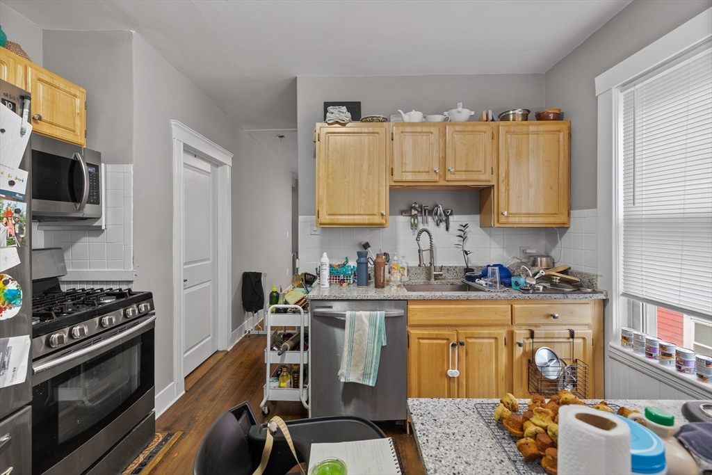 14-16 Malvern Avenue Somerville, MA 02144 - Photo 18 of 39 a kitchen with a stove a sink and cabinets