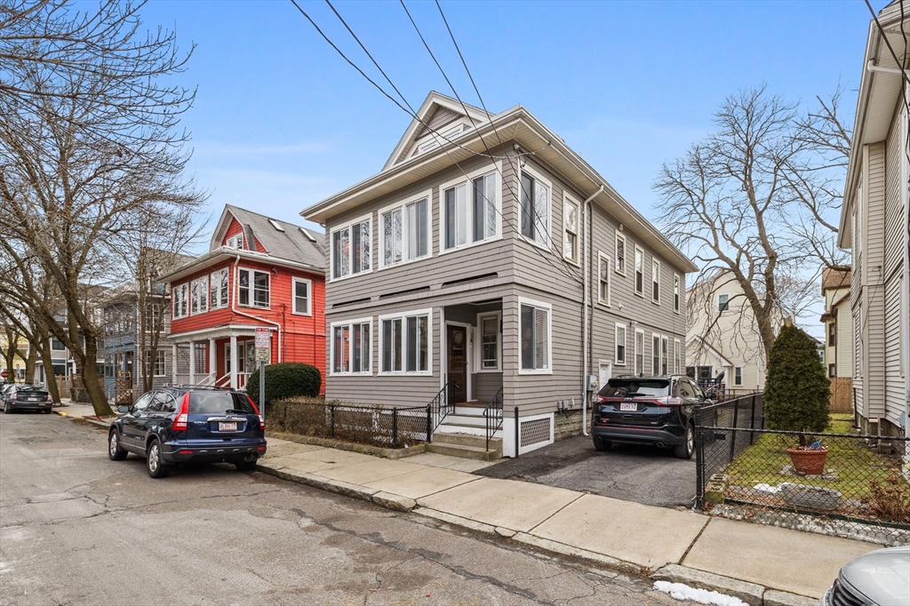 14-16 Malvern Avenue Somerville, MA 02144 - Photo 2 of 39 a car parked in front of a white house