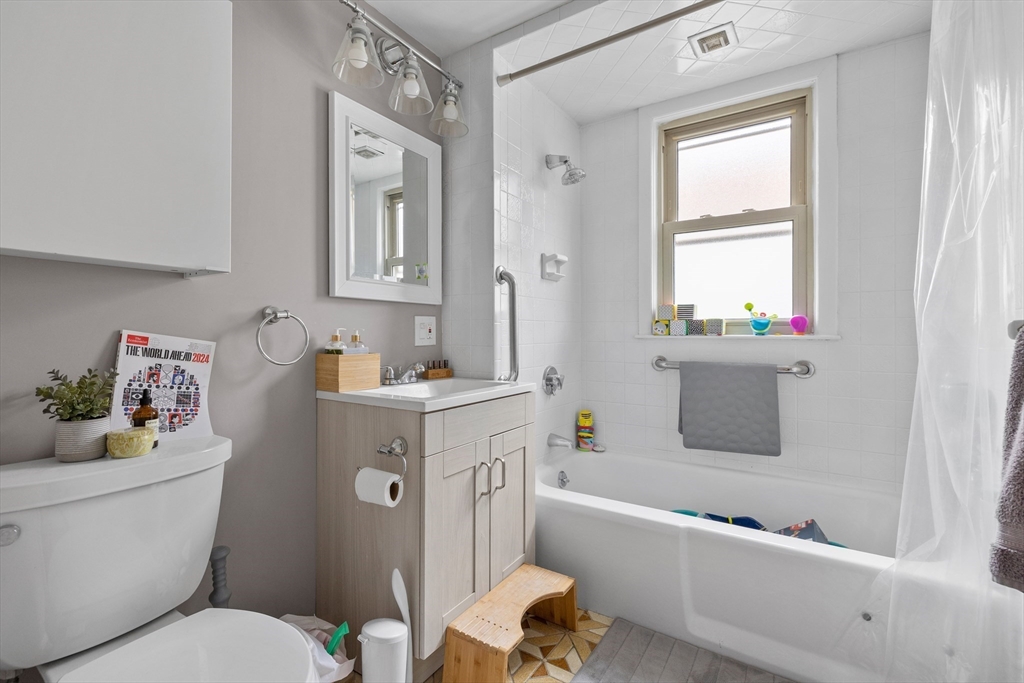 14-16 Malvern Avenue Somerville, MA 02144 - Photo 30 of 39 a bathroom with a sink mirror vanity and toilet