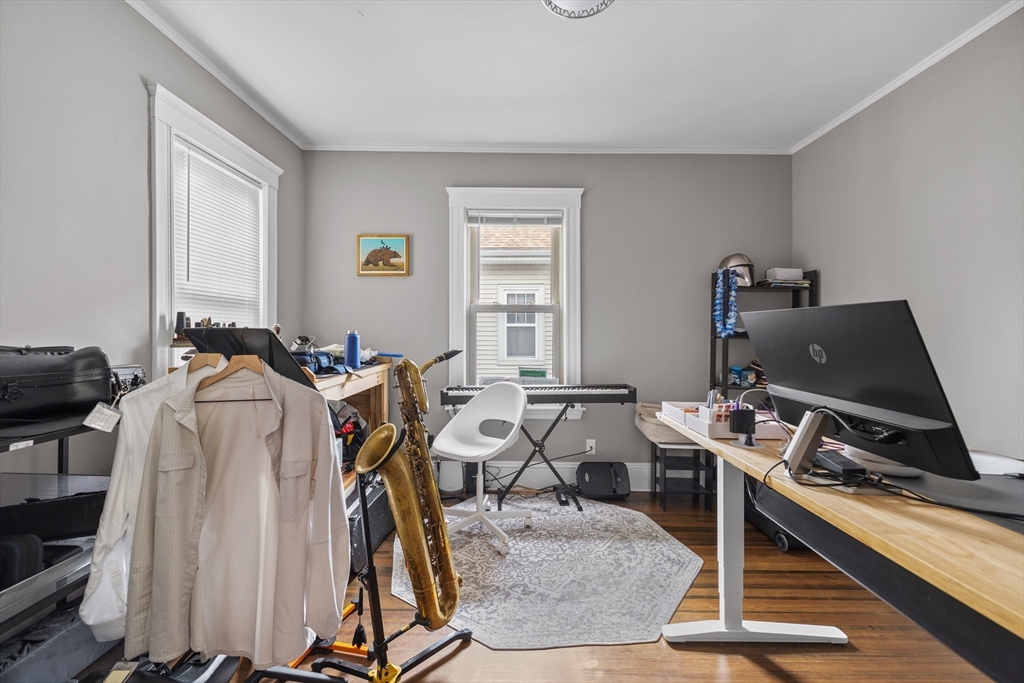 14-16 Malvern Avenue Somerville, MA 02144 - Photo 33 of 39 a room with gym equipment and a mirror