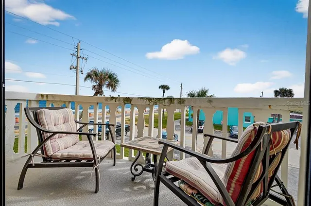 a view of a chairs and table in patio