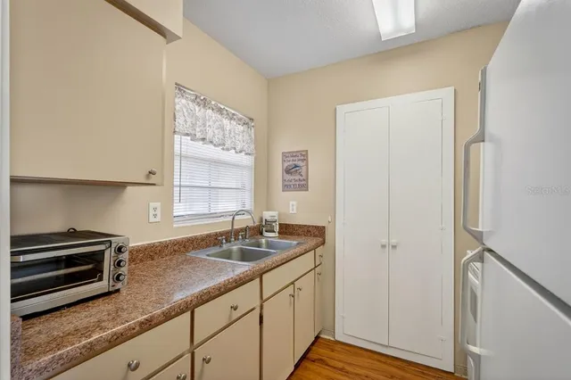 a kitchen with granite countertop a sink and a stove top oven