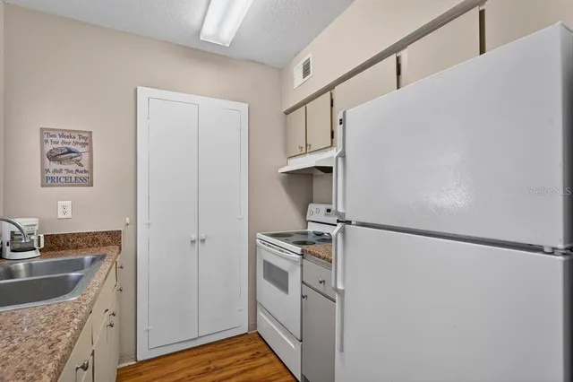 a kitchen with cabinets and stainless steel appliances