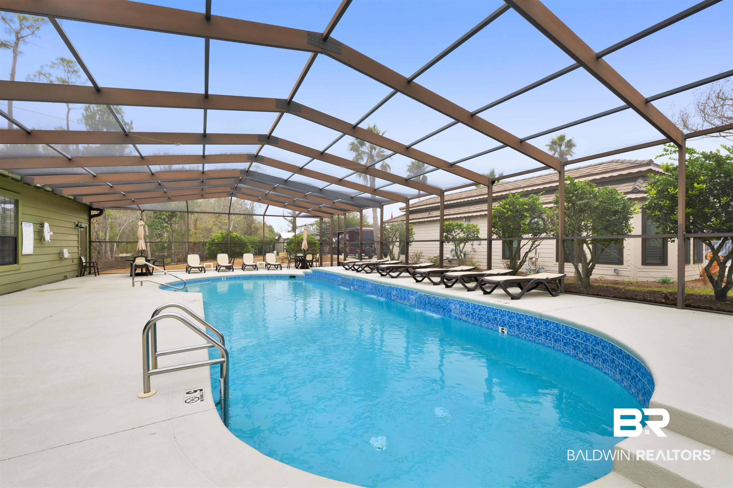 4650 Griffith Marina Road, Unit LOT 24 Orange Beach, AL 36561 - Photo 23 of 34 Community pool with glass enclosure, a patio, and a sunroom