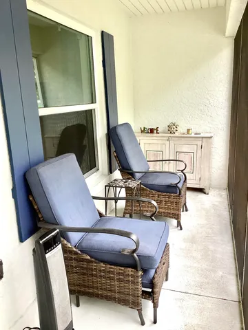 a view of a living room with furniture and a window