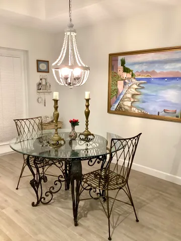 a view of a dining room with furniture wooden floor and a chandelier