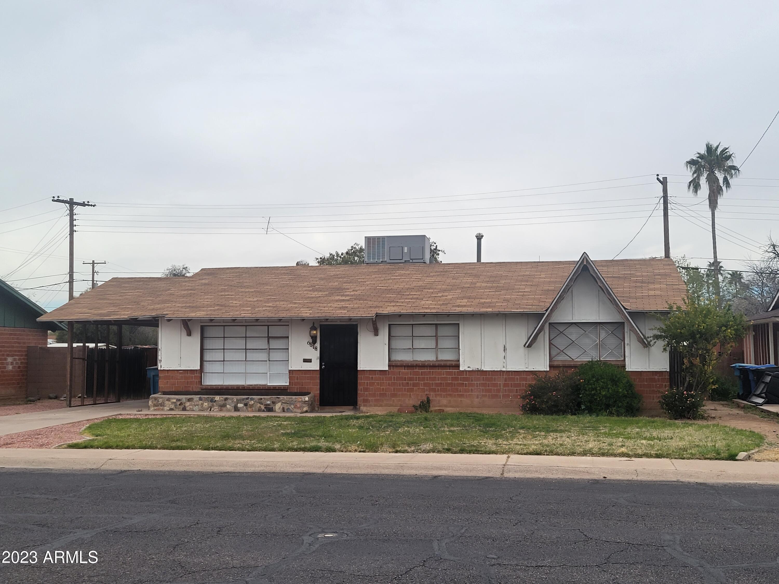 6518 North 41st Avenue Phoenix, AZ 85019 - Photo 1 of 13 a front view of a house with a yard