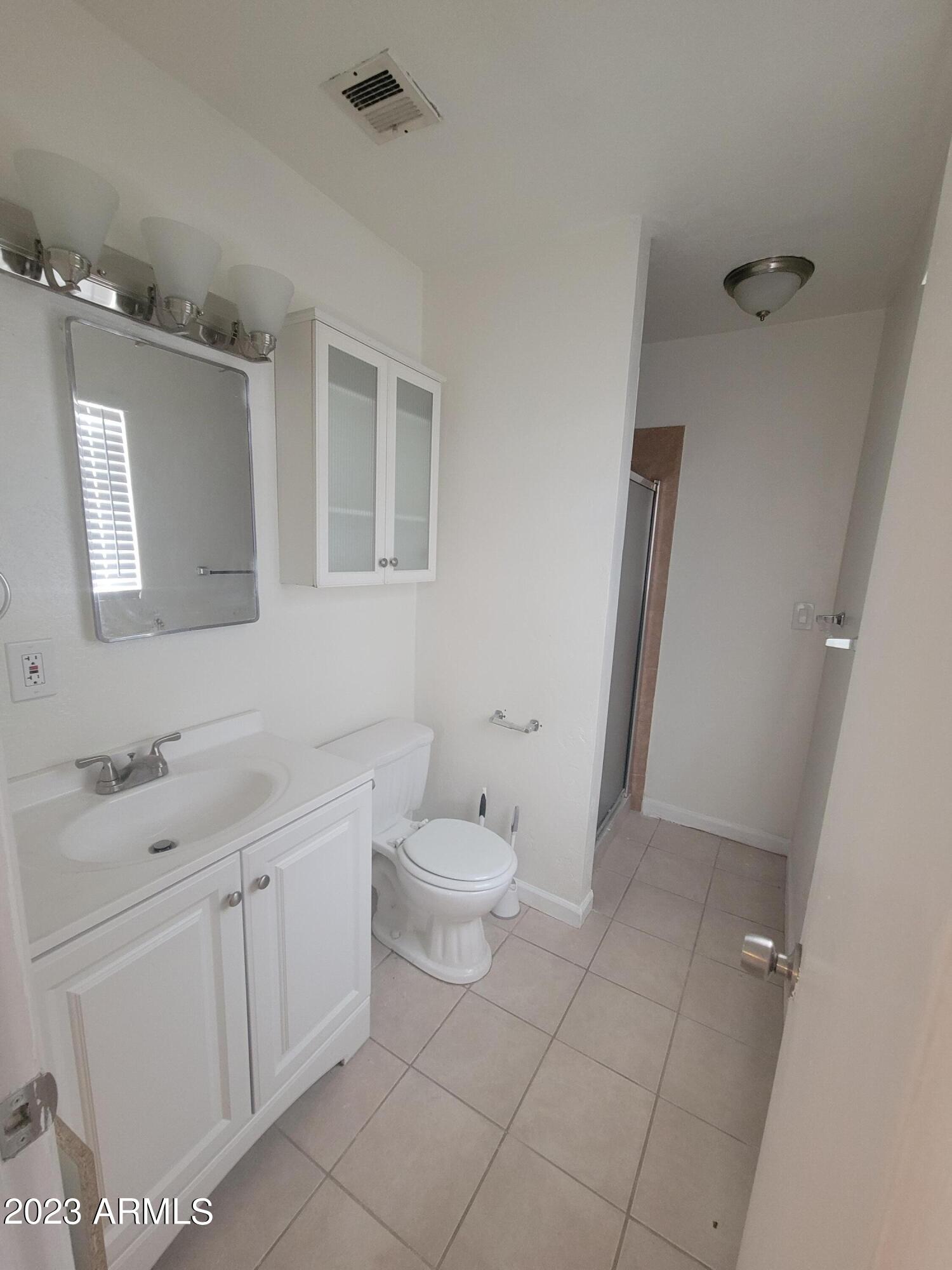 6518 North 41st Avenue Phoenix, AZ 85019 - Photo 11 of 13 a bathroom with a toilet sink and mirror
