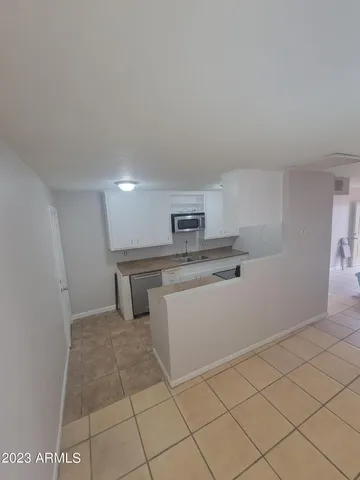 a kitchen with white cabinets