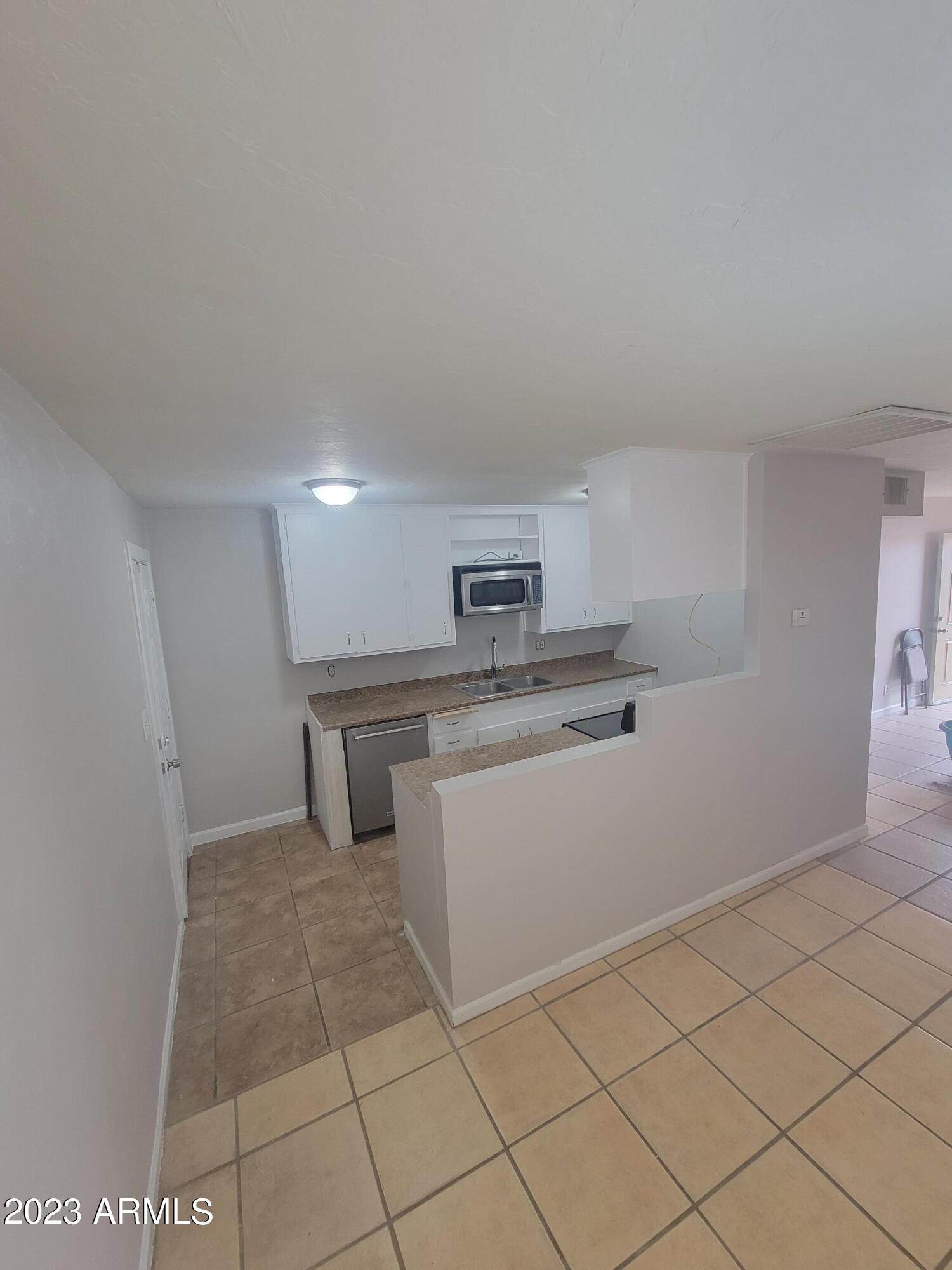 6518 North 41st Avenue Phoenix, AZ 85019 - Photo 3 of 13 a kitchen with white cabinets