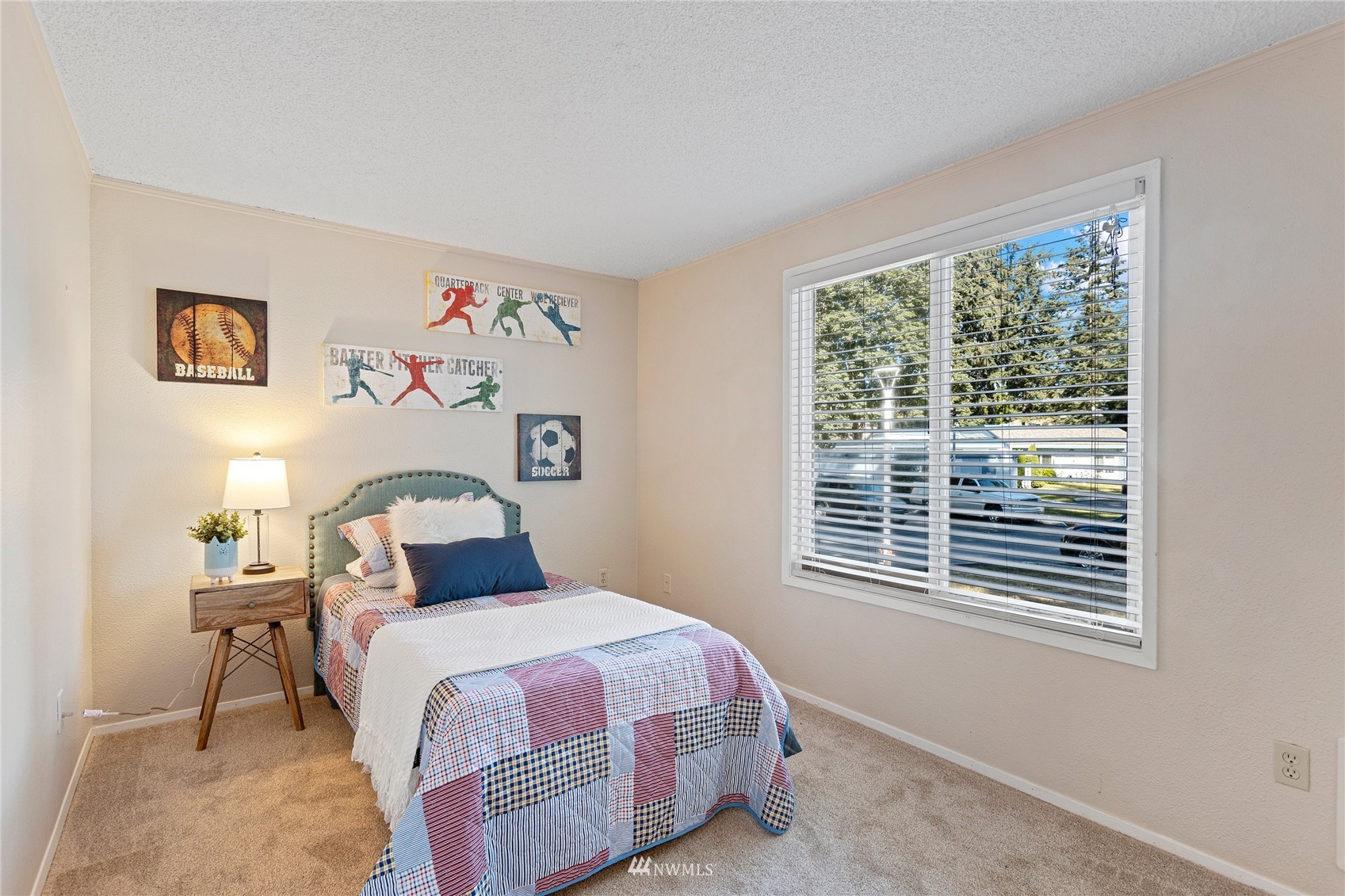 4308 Northeast Sunset Boulevard, Unit O2 Renton, WA 98059 - Photo 11 of 22 a bedroom with a bed and a window