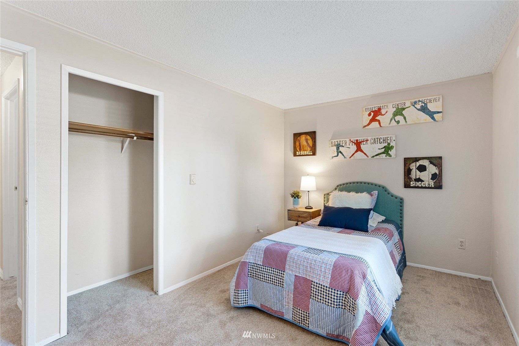4308 Northeast Sunset Boulevard, Unit O2 Renton, WA 98059 - Photo 12 of 22 a bedroom with a bed and painting on the wall