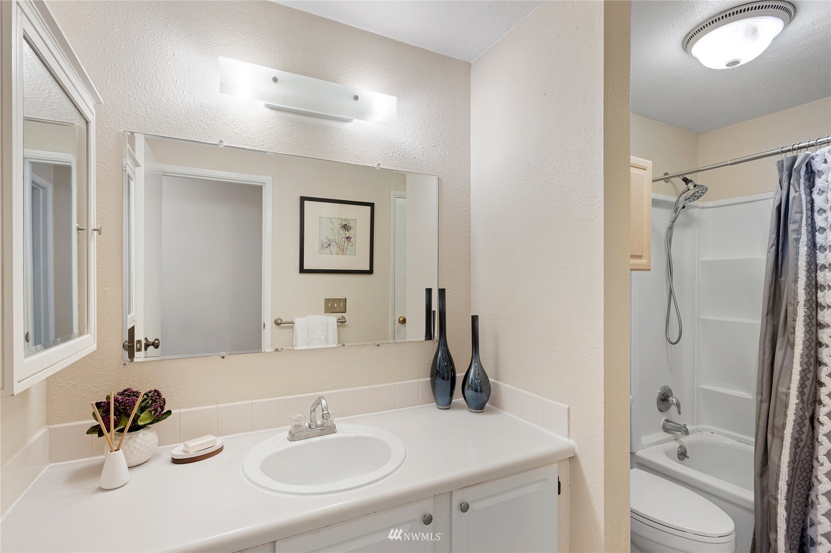 4308 Northeast Sunset Boulevard, Unit O2 Renton, WA 98059 - Photo 15 of 22 a bathroom with a sink a toilet and shower