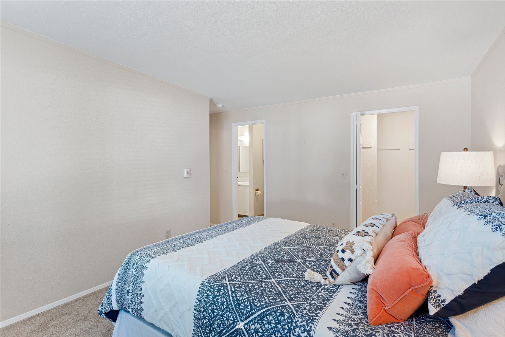 4308 Northeast Sunset Boulevard, Unit O2 Renton, WA 98059 - Photo 17 of 22 a bedroom with a bed and a lamp