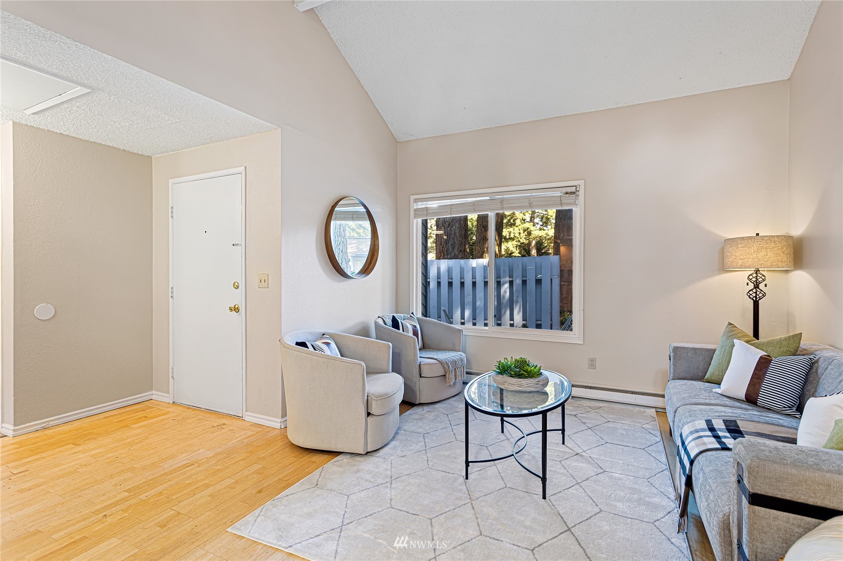 4308 Northeast Sunset Boulevard, Unit O2 Renton, WA 98059 - Photo 2 of 22 a living room with furniture a window and a lamp