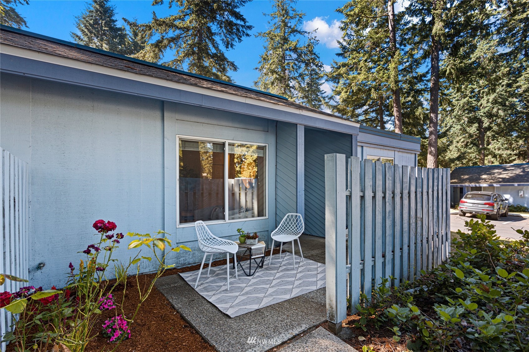 4308 Northeast Sunset Boulevard, Unit O2 Renton, WA 98059 - Photo 21 of 22 a table and chairs in front of a house