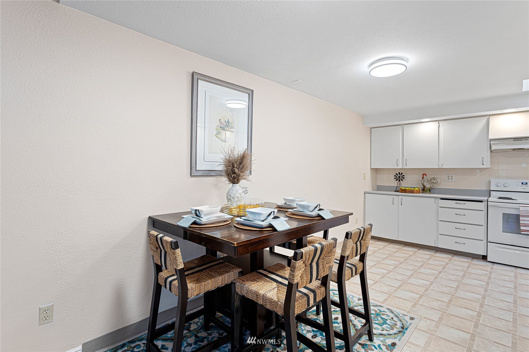 4308 Northeast Sunset Boulevard, Unit O2 Renton, WA 98059 - Photo 4 of 22 a kitchen with a table and chairs in it