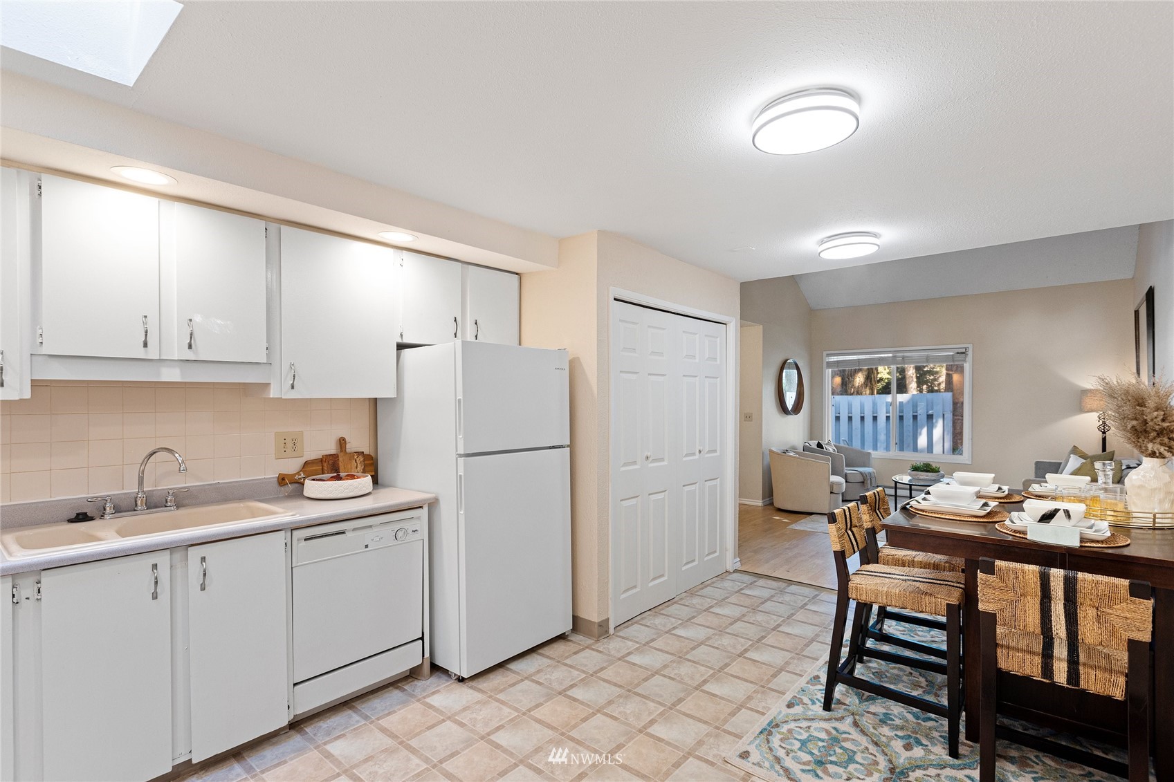 4308 Northeast Sunset Boulevard, Unit O2 Renton, WA 98059 - Photo 9 of 22 a kitchen with a sink a refrigerator and cabinets