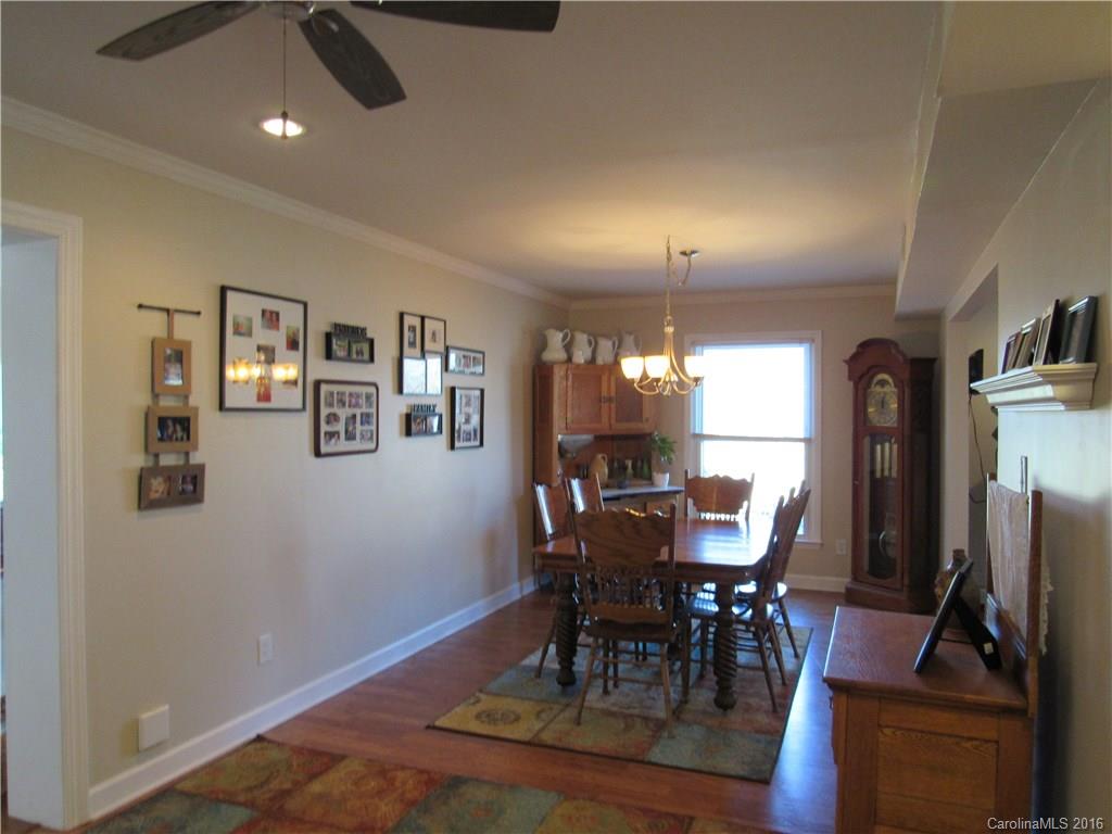 1219 Stevens Road Monroe, NC 28110 - Photo 11 of 24 a view of a dining room with furniture window and wooden floor