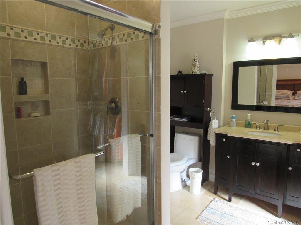 1219 Stevens Road Monroe, NC 28110 - Photo 15 of 24 a en suite bathroom with a shower sink and mirror