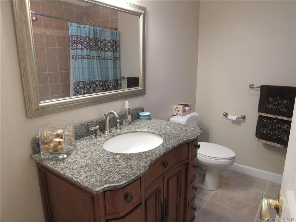 1219 Stevens Road Monroe, NC 28110 - Photo 20 of 24 a bathroom with a granite countertop toilet sink and mirror