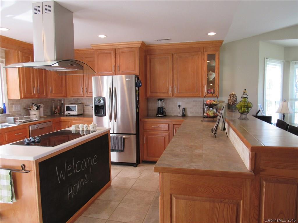 1219 Stevens Road Monroe, NC 28110 - Photo 4 of 24 a kitchen with stainless steel appliances granite countertop a sink stove and refrigerator