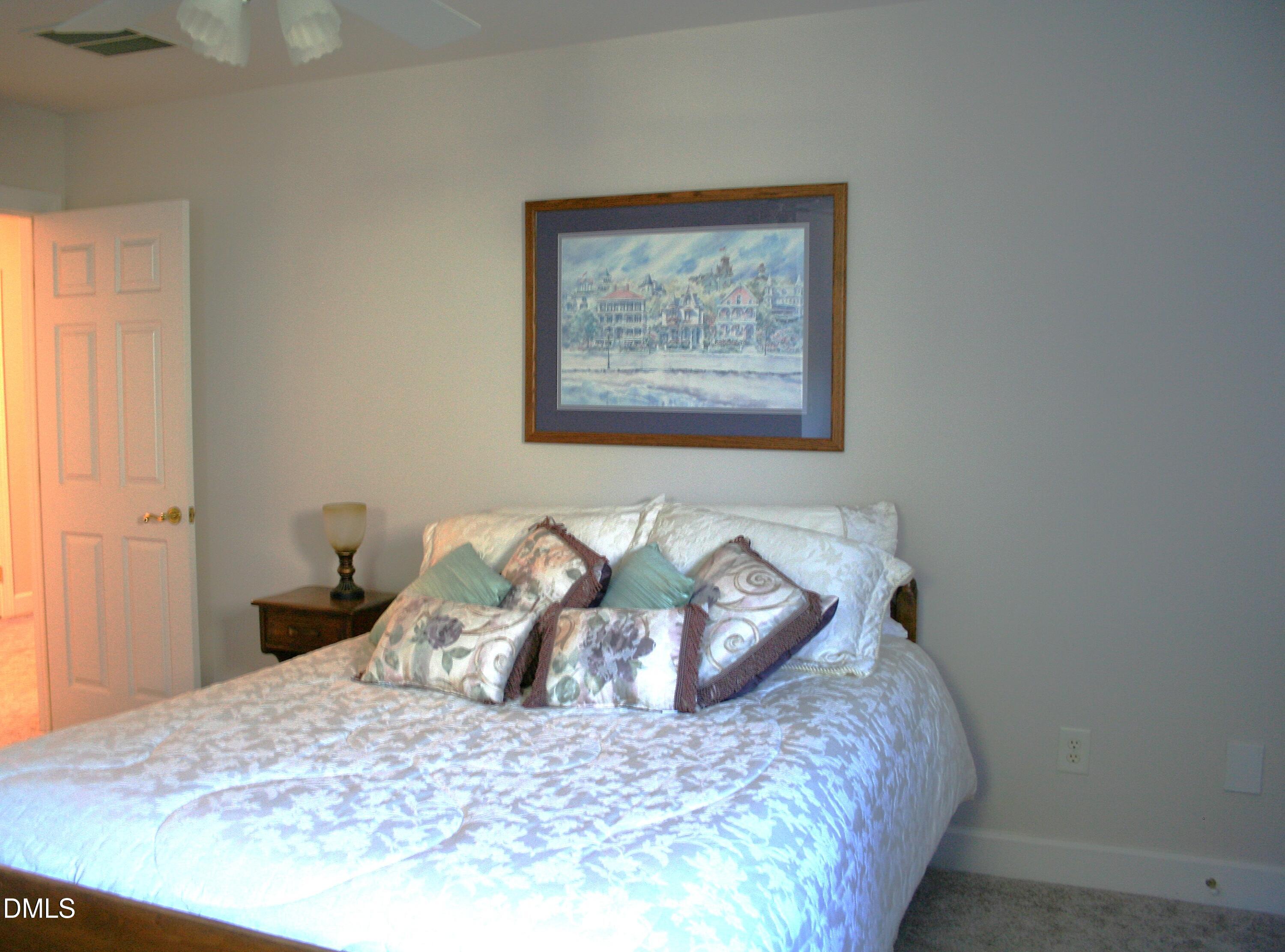 220 Jordan Narron Road Selma, NC 27576 - Photo 42 of 87 a bedroom with a bed and a wall painting