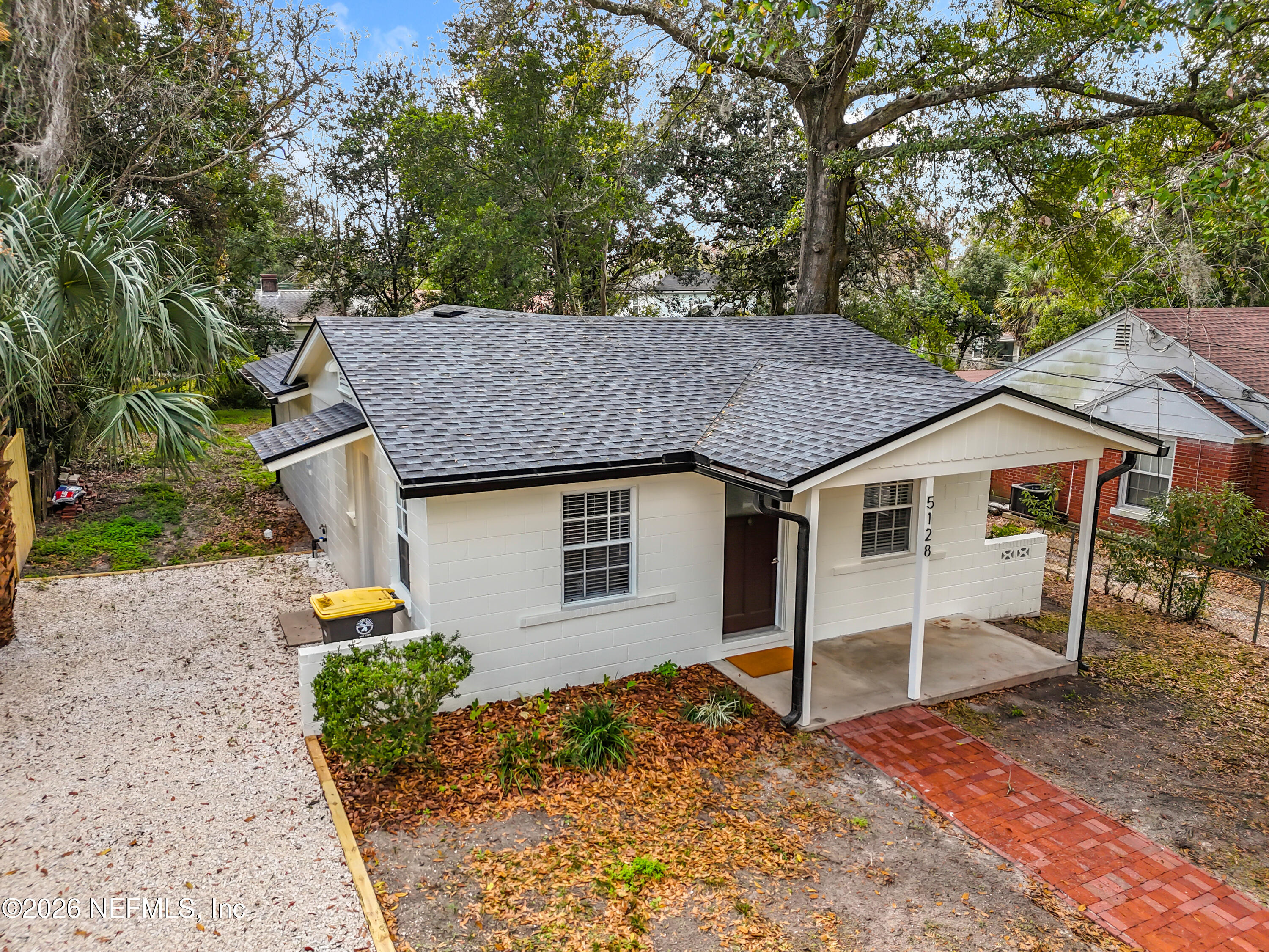 a house that has a tree in front of it