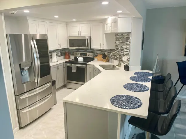 a kitchen with a dining table and chairs