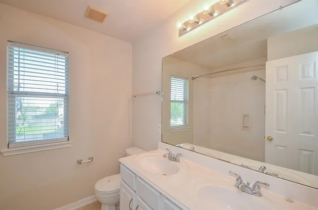 a view of a room with windows and chandelier